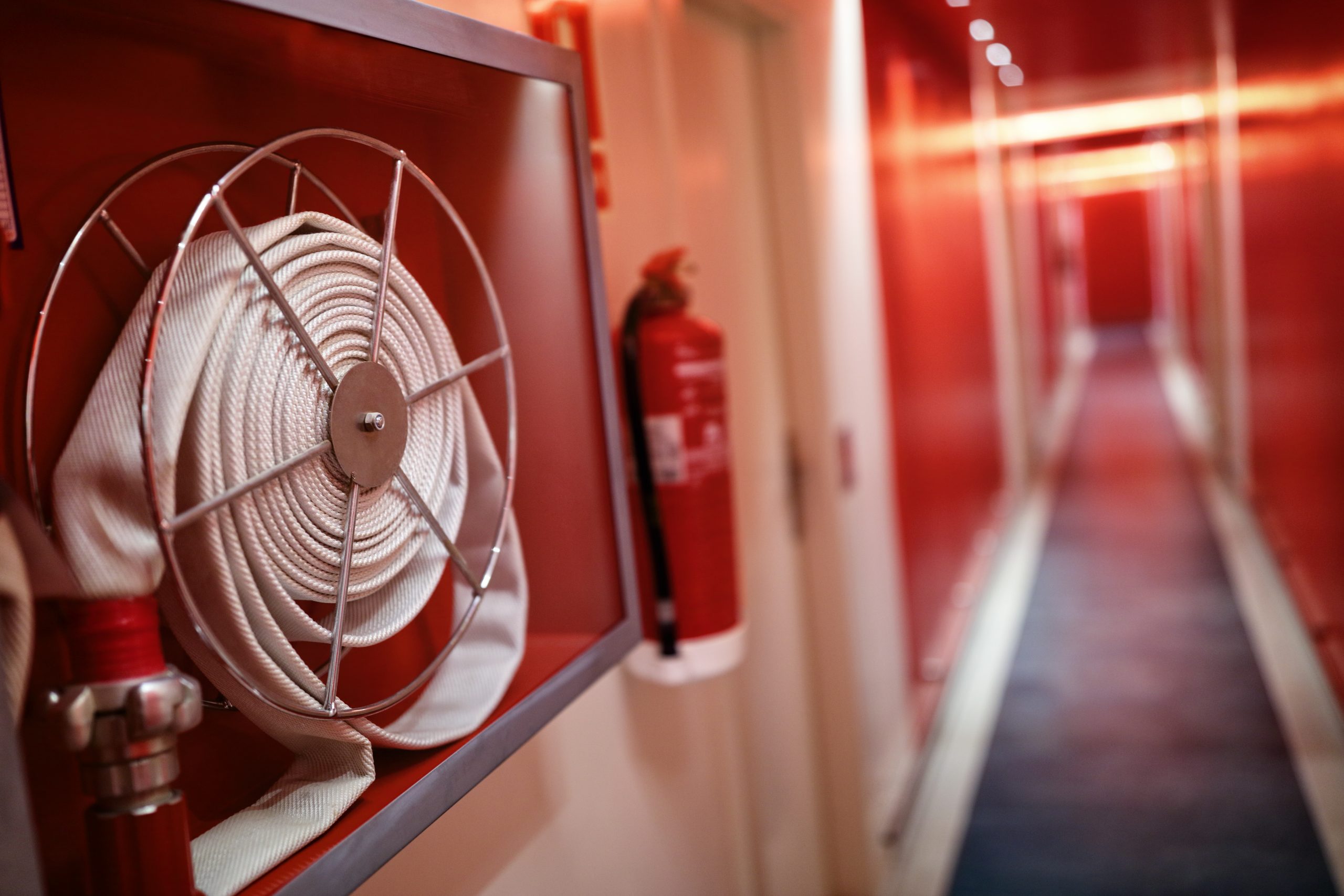 Fire extinguisher and hose reel in hotel corridor, Fire Watch Company, Fire Watch Services, NFPA 101, Florida Fire Safety, Emergency Fire Watch, Compliance Services, Fire Watch Company Boca Raton, Fire Watch Patrol, Fire Watch Companies, Fire Watch Security, Fire Watch Services, Fire Safety, NFPA 101 Life Safety Code